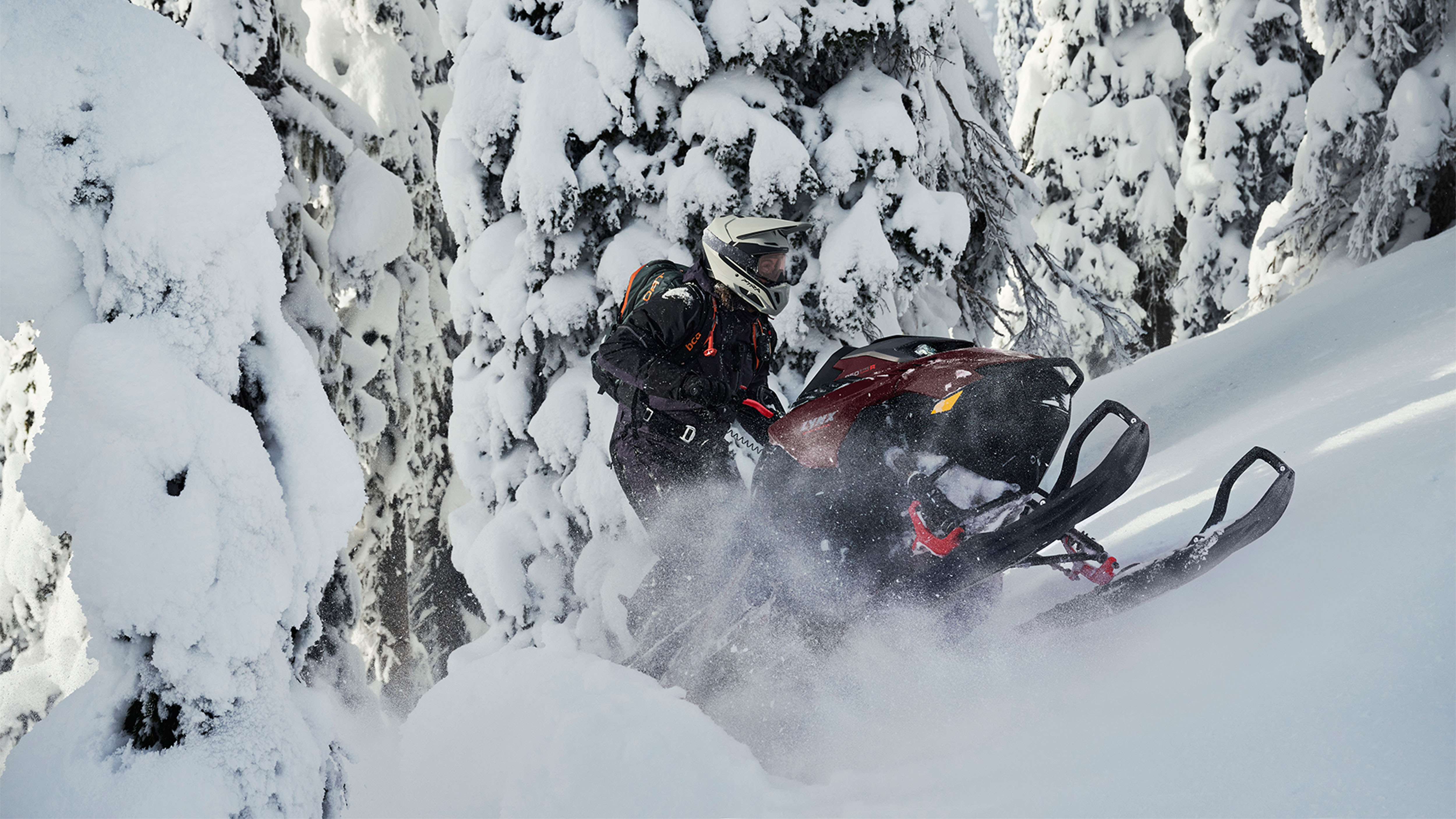 Lynx Shredder DS snowmobile climbing a steep hill