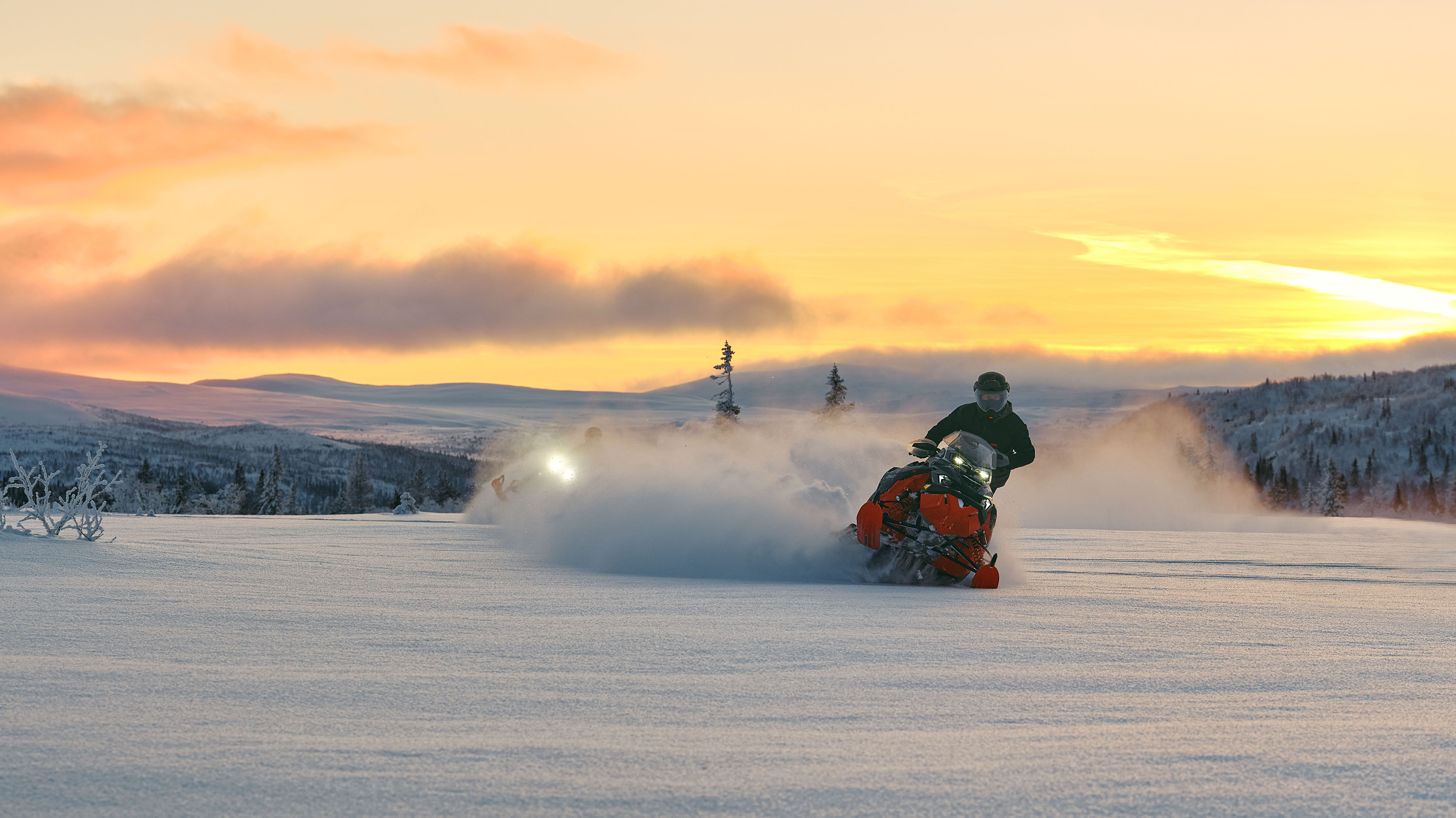 Snowmobiler on the 2026 Lynx Brutal RE snowmobile carving his way through the fresh powder of a snow-covered landscape.