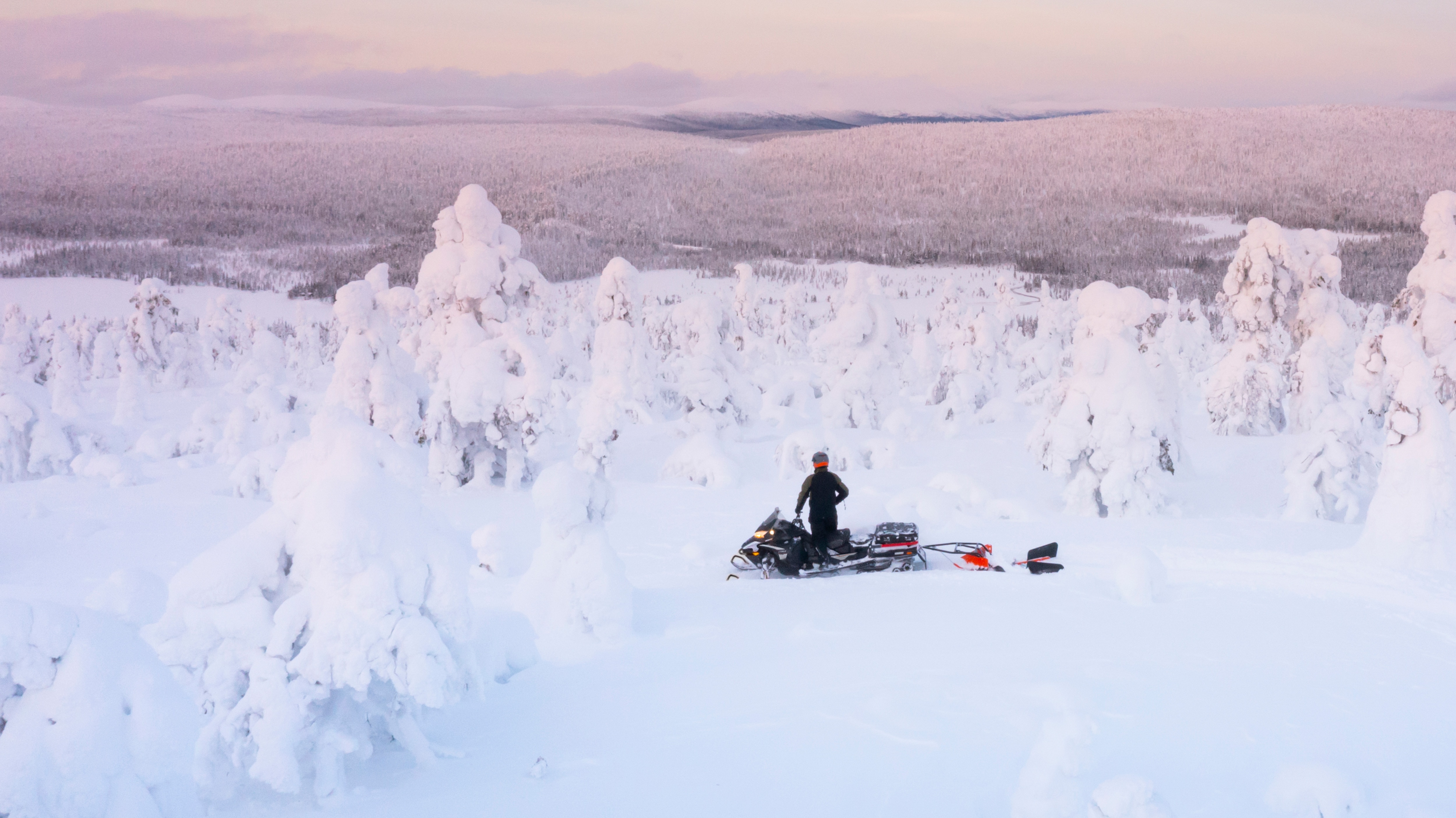 Family preparing to ride a Lynx 59 Ranger snowmobile