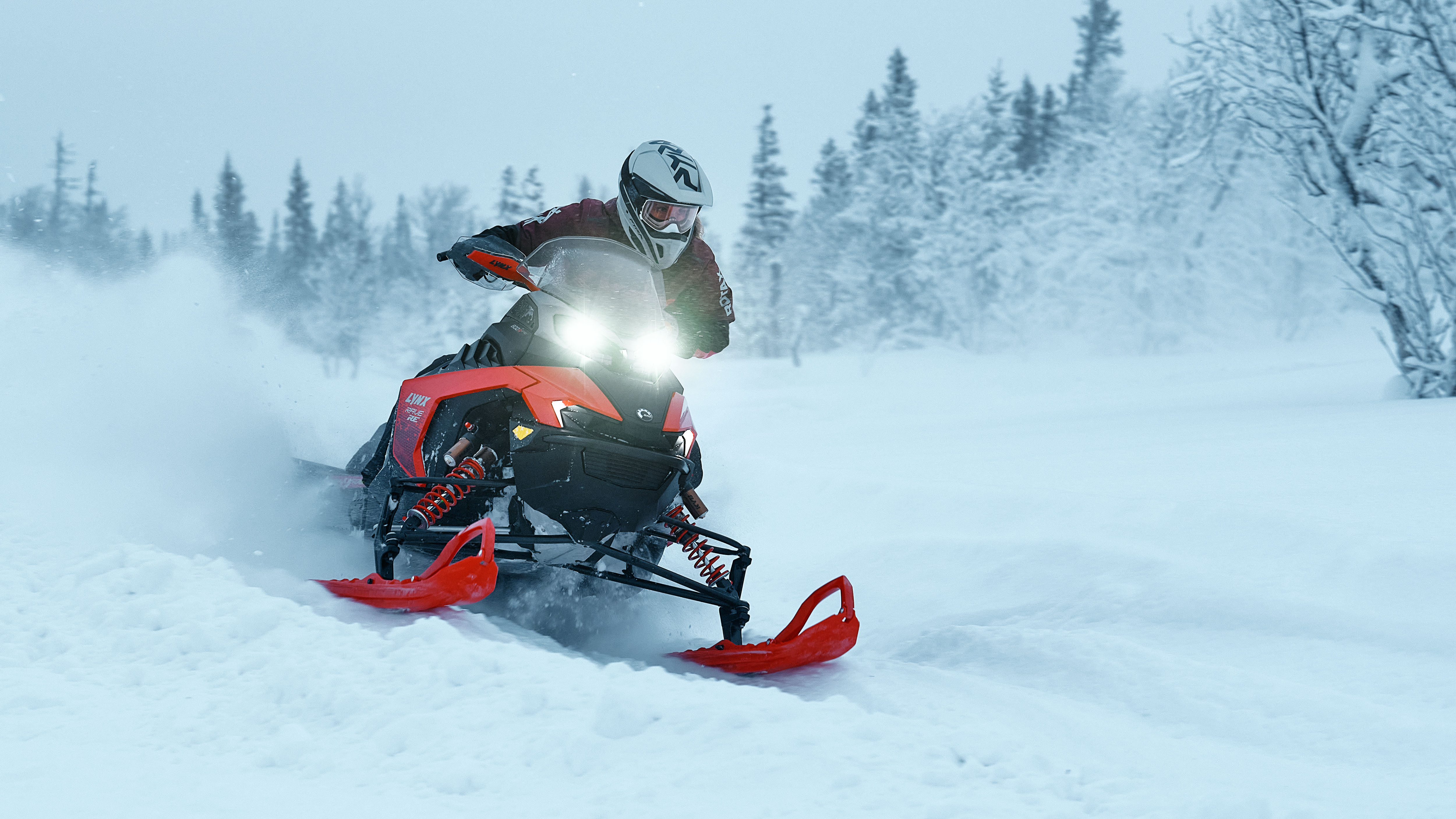 Lynx Rave GLS 2025 snowmobile riding aggressively on bumpy trail