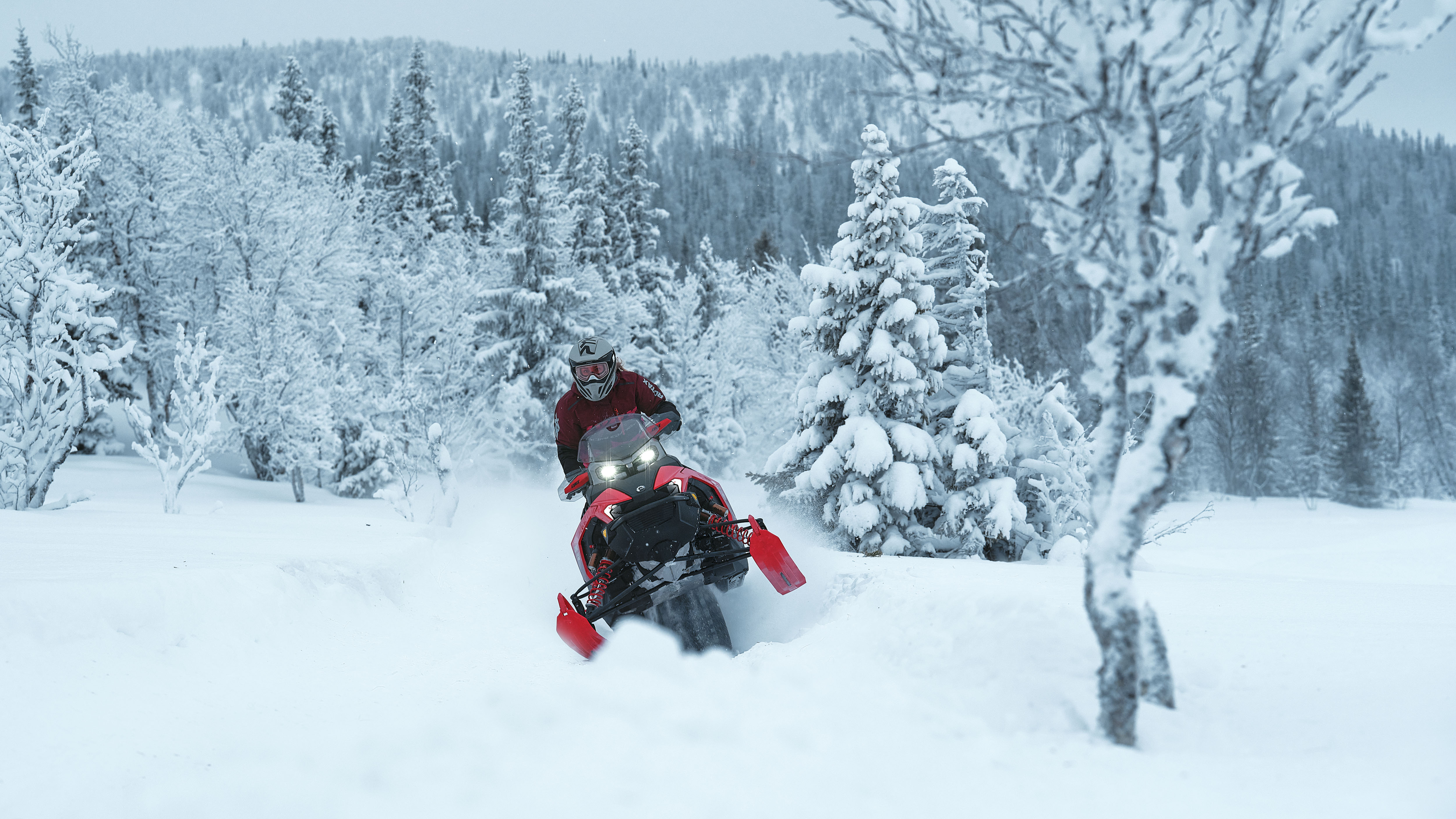 Two Lynx Rave 2025 snowmobiles riding sporty on snowy trail