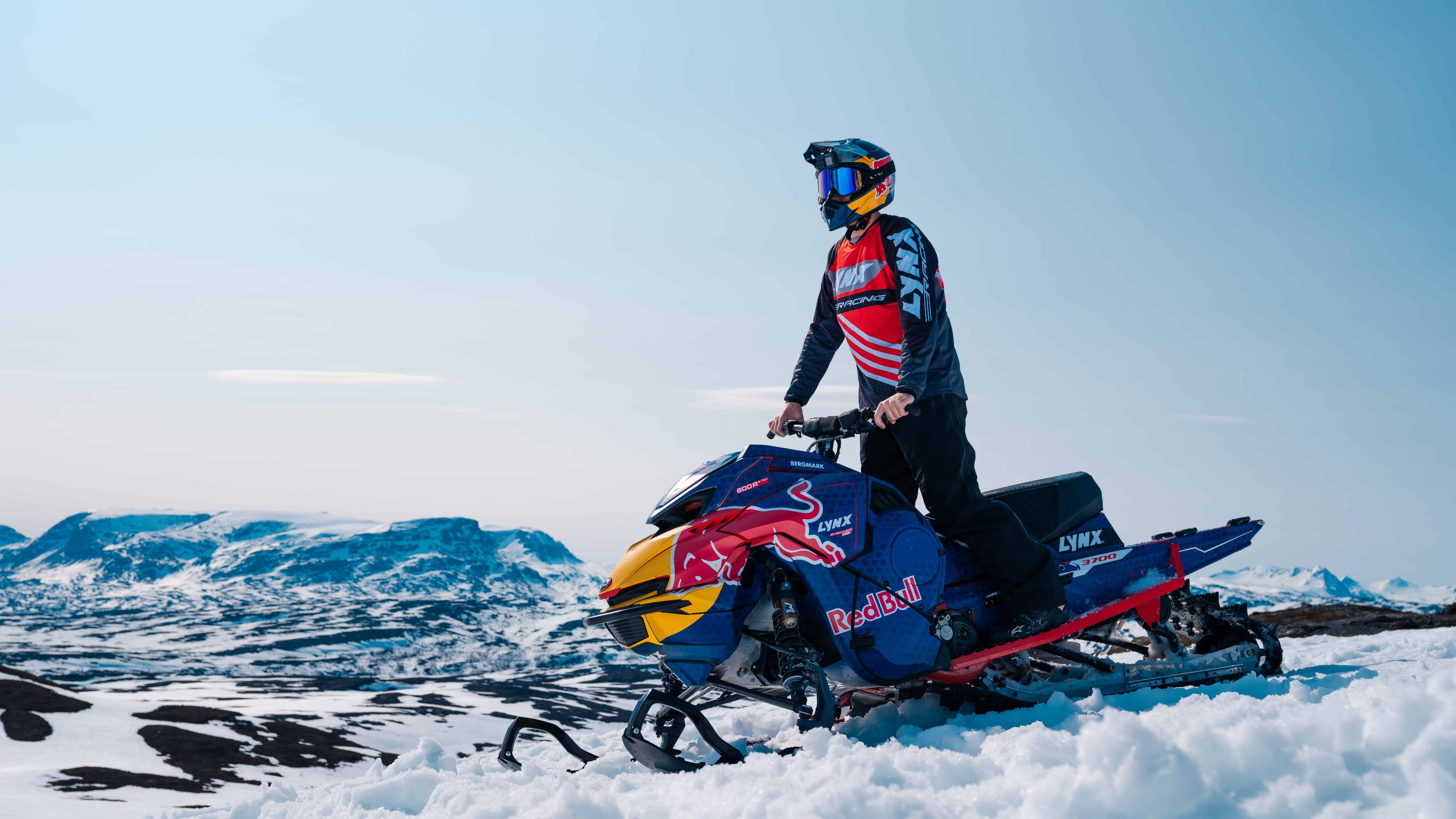 Lynx ambassador Andreas Bergmark standing on his 2025 Lynx Shredder snowmobile.