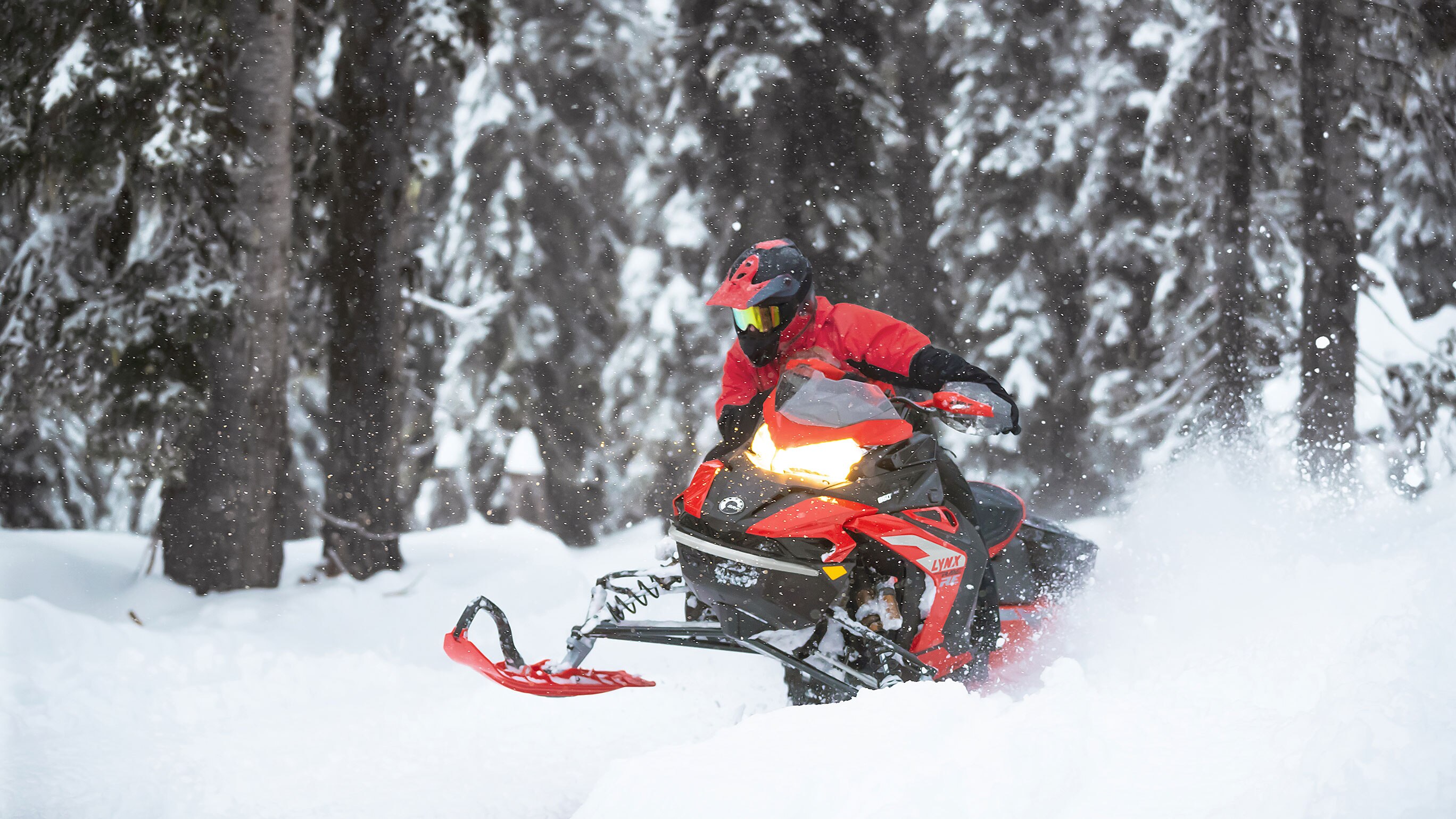 Lynx Rave RE snowmobile curving on a trail