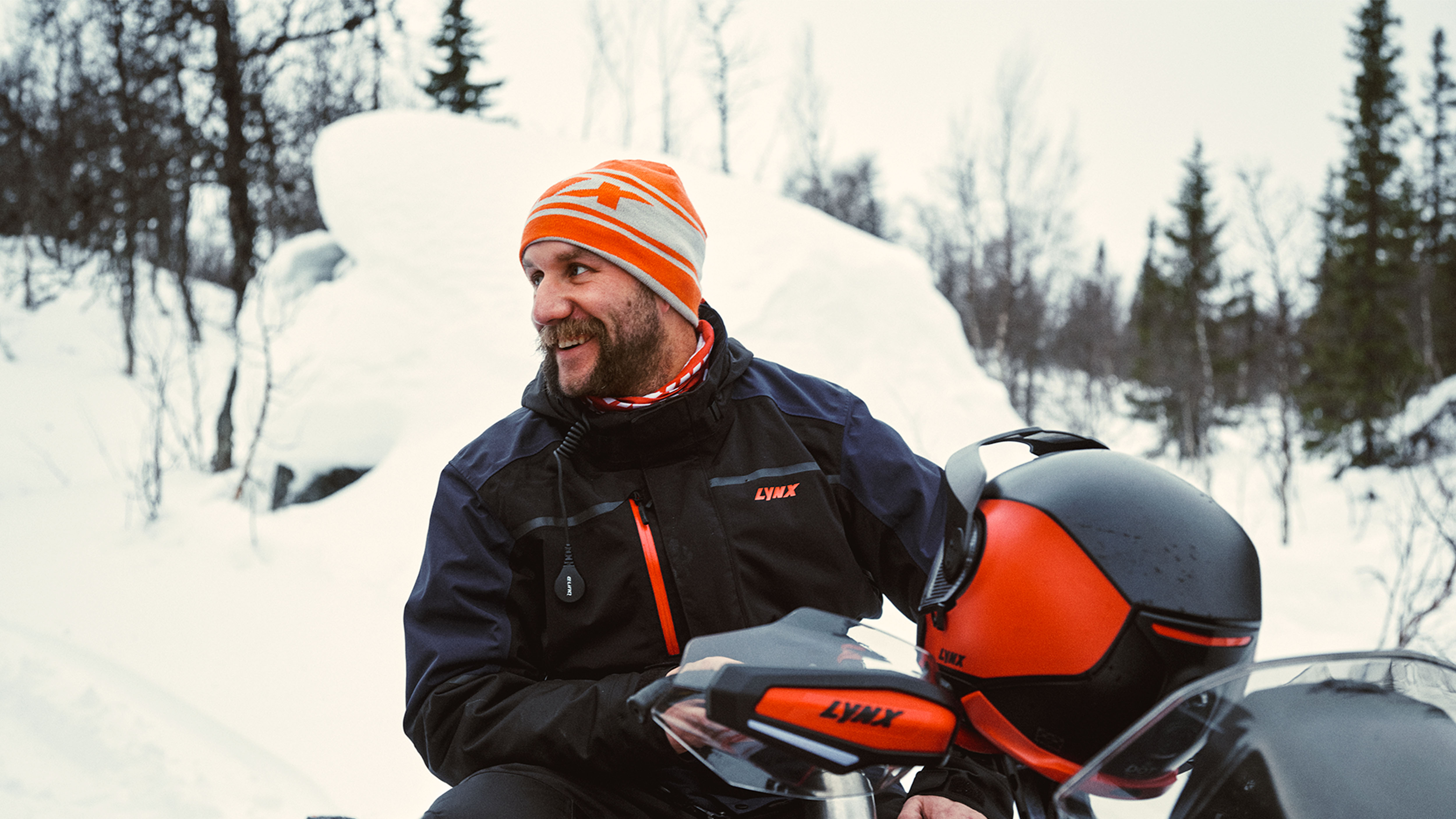 Man laughing on Lynx snowmobile