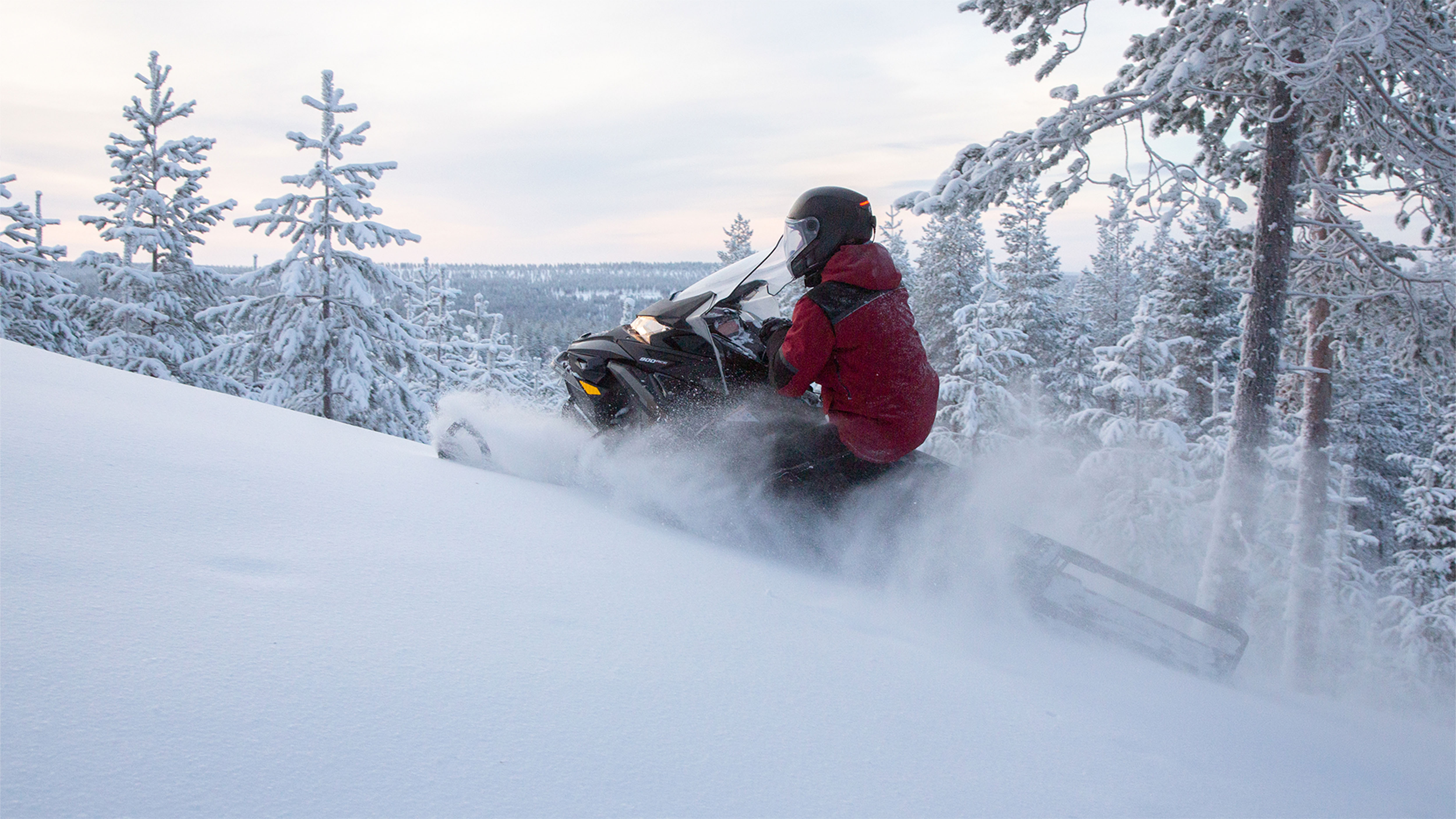 Lynx Commander Limited 2025 snowmobile riding uphill in deep snow