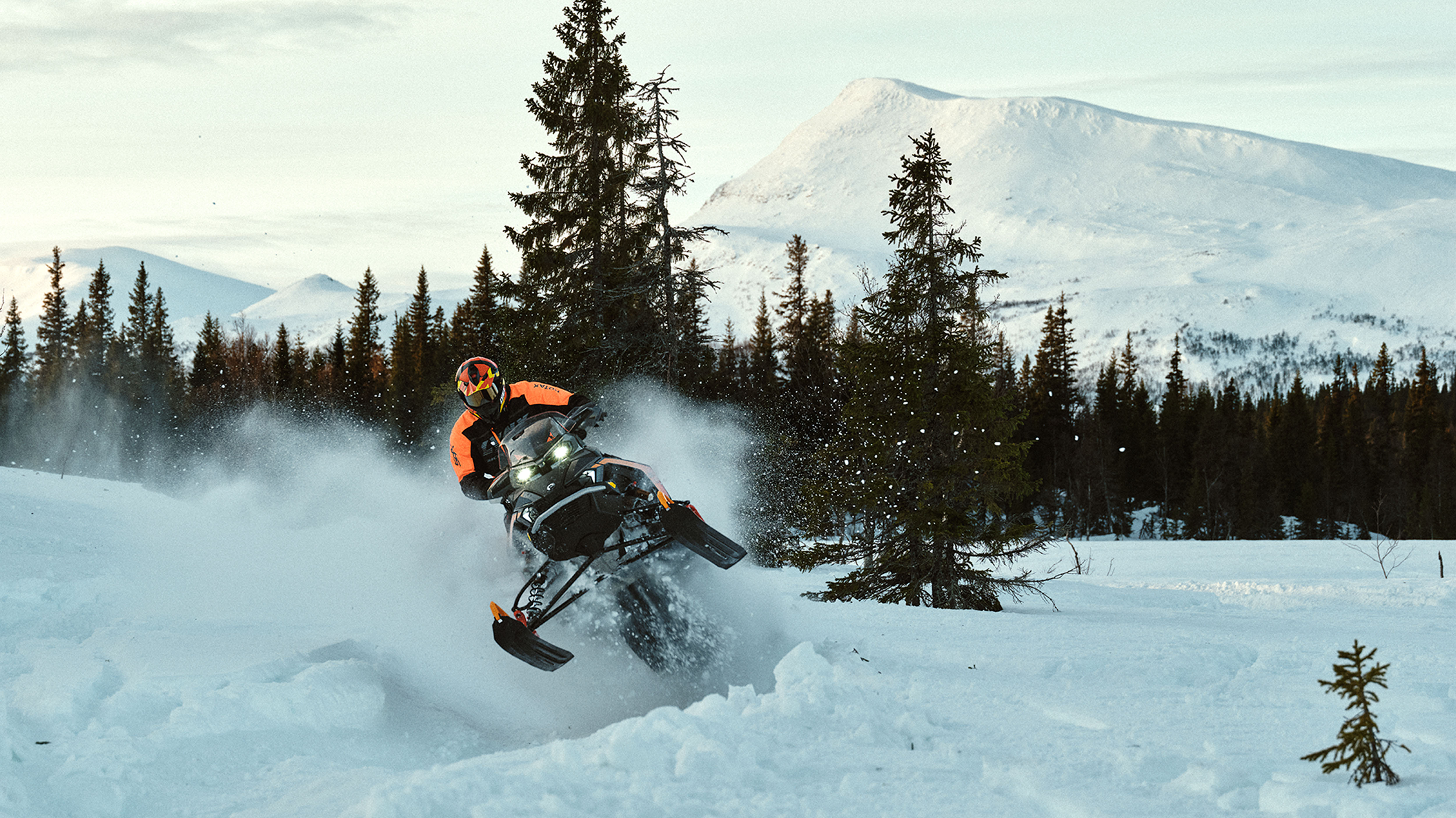 Lynx Rave GLS 2025 snowmobile riding aggressively on bumpy trail